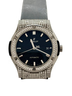 Luxury watch with diamond-studded case on a light background