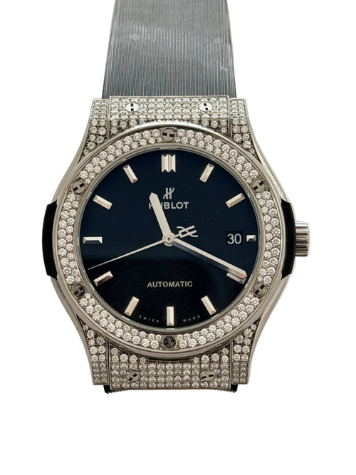 Luxury watch with diamond-studded case on a light background